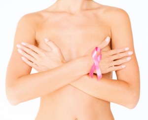 woman covering breasts holding breast cancer ribbon